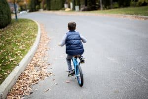 child riding bike in street